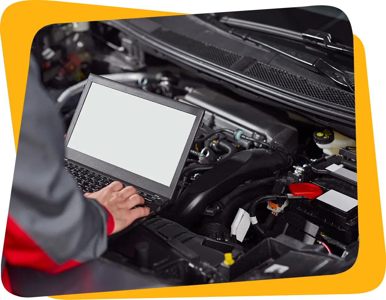 Mechanic using laptop for car diagnostics.